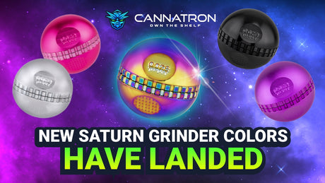 All 10 Ooze Saturn Globe Grinder colors are in a pyramid layout on a white marble counter. In order from front to back: rainbow, pink, purple, red, green, teal, black, silver, stealth black, and chrome.