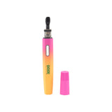 A Sunset Ooze Hot Spoon stands upright with the travel cap to the side on a white background