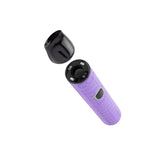 Angled view of purple Pinch dry herb vape with cap removed to show ceramic chamber